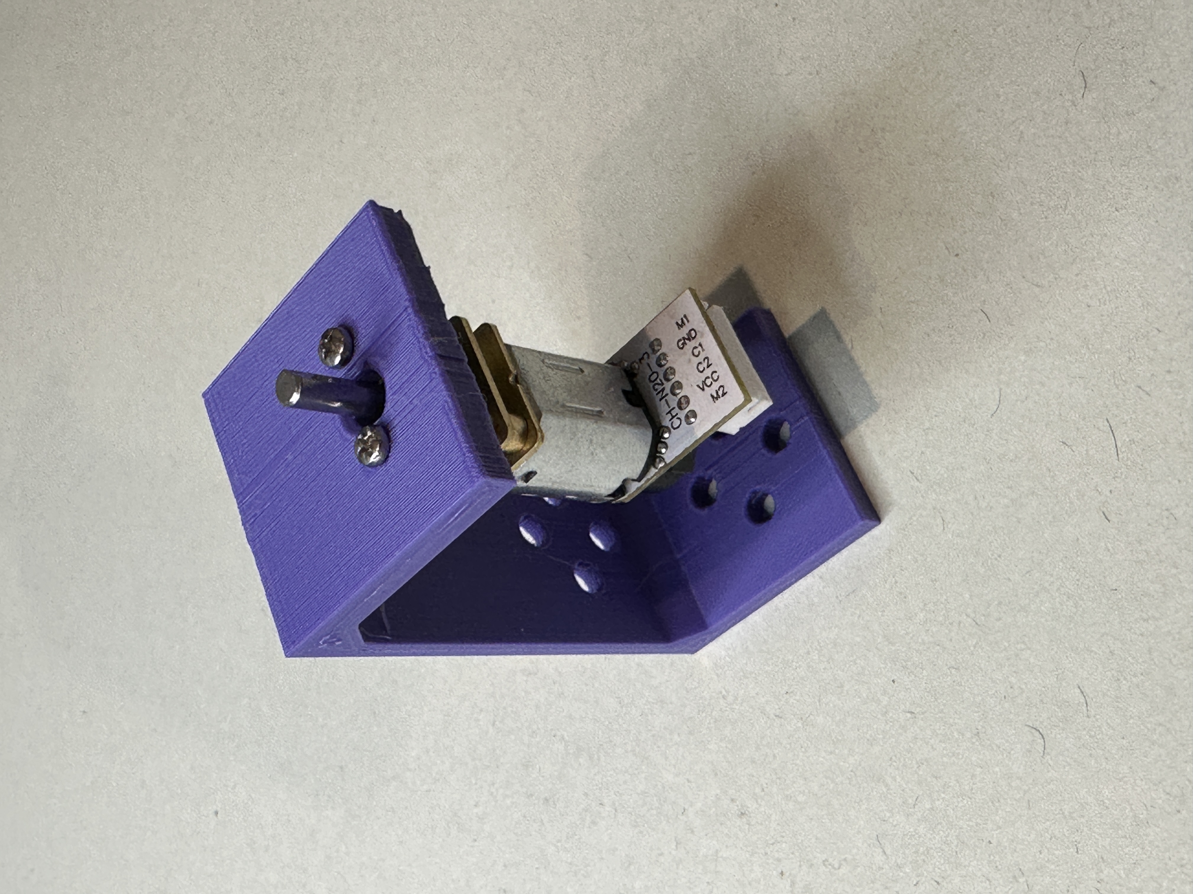 Attaching the DC motor with the two M1.6 - 4mm long screws to the torque lab base.